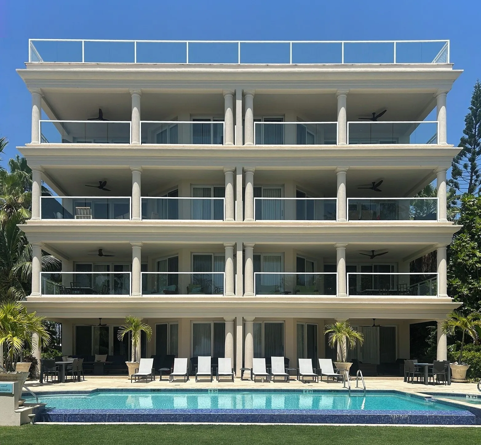 The back of the Sea Breeze building from the pool, with each rental condo's terraces highlighted: The Penthouse on the top floor and rooftop, Condo 8 on the fourth floor, Condo 5 on the third floor, Condos 3 and 4 on the second floor